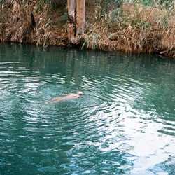 Women floating in Jordan River