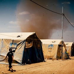 arising sandstorm in a refugee camp