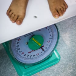 A child being weighed at a health clinic sponsored by UNICEF