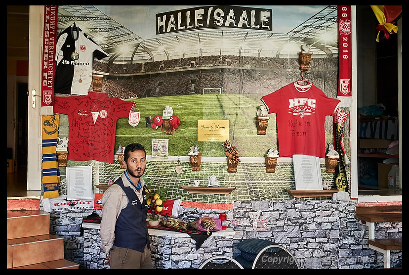 Ismet Tekin, owner of“Kiez Döner”, at the memorial wall for victims of the Halle synagogue attack inside the restaurant.