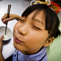 A girl enjoys a meal cooked for her at a children’s centre in Saigon, Vietnam.