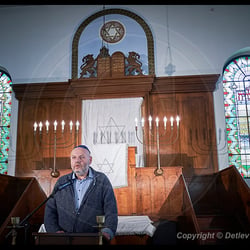 Max Privorozki, President of the Jewish Community of Halle, speaks from the bimah of the synagogue in Halle, Germany