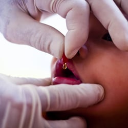 A child being given vitamin supplements at a health clinic sponsored by UNICEF