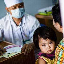 A child has a health check at a health clinic sponsored by UNICEF