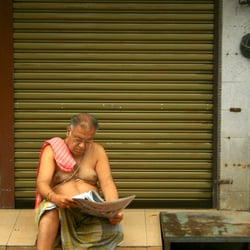 man reading newspaper