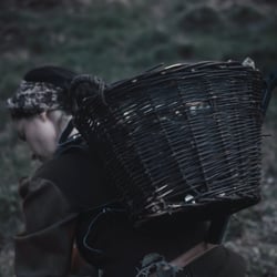 The mother is collecting wood branches for the fire at home